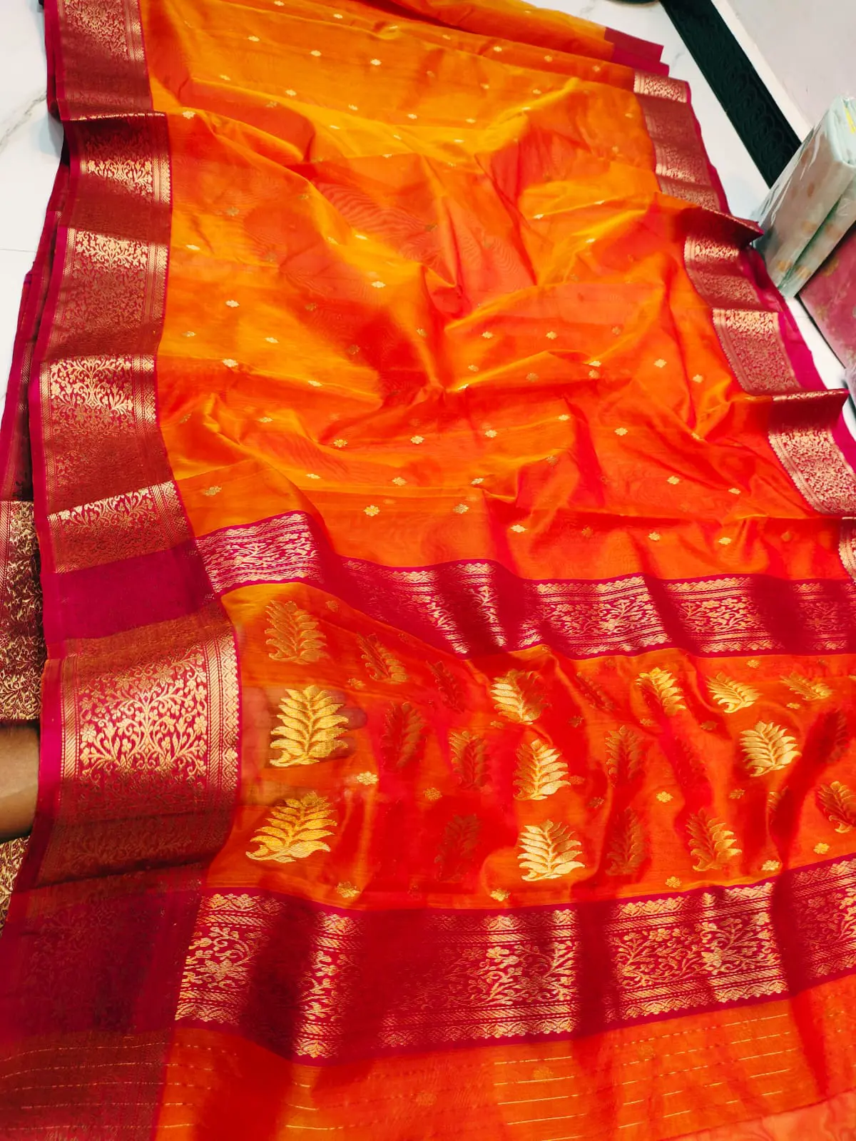 Saffron Sunset with Intricate Leaf Motifs and Crimson Zari Border Kataan Silk